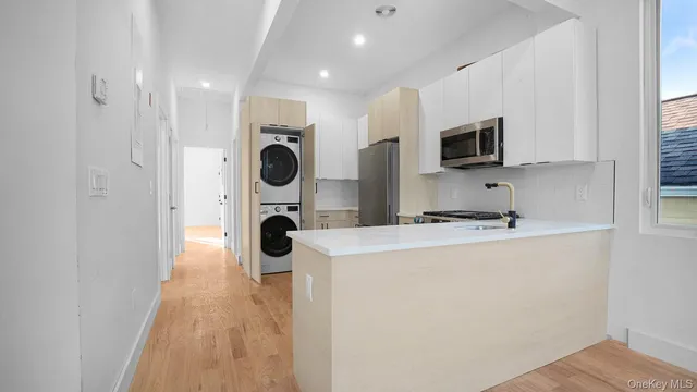 a kitchen with stainless steel appliances a refrigerator and a microwave