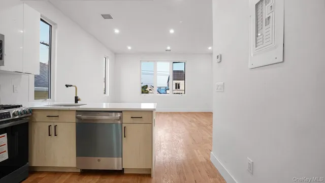 a kitchen with a sink and wooden floor
