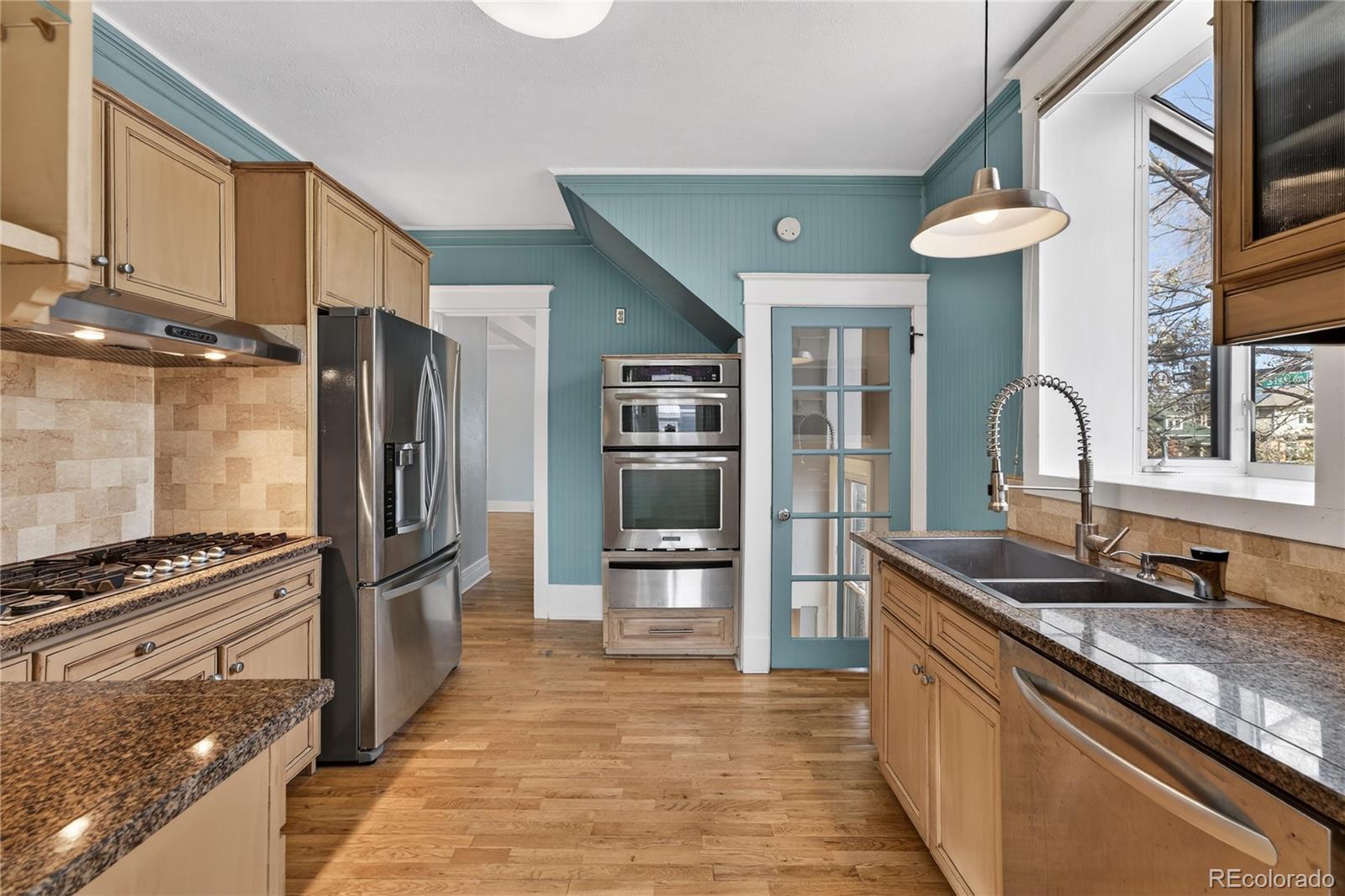 3056 York Street Denver, CO 80205 - Photo 12 of 44 a kitchen with stainless steel appliances granite countertop a refrigerator and a sink