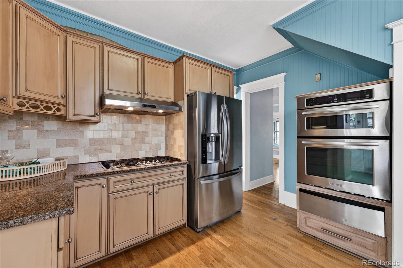 3056 York Street Denver, CO 80205 - Photo 13 of 44 a kitchen with granite countertop a refrigerator and stove