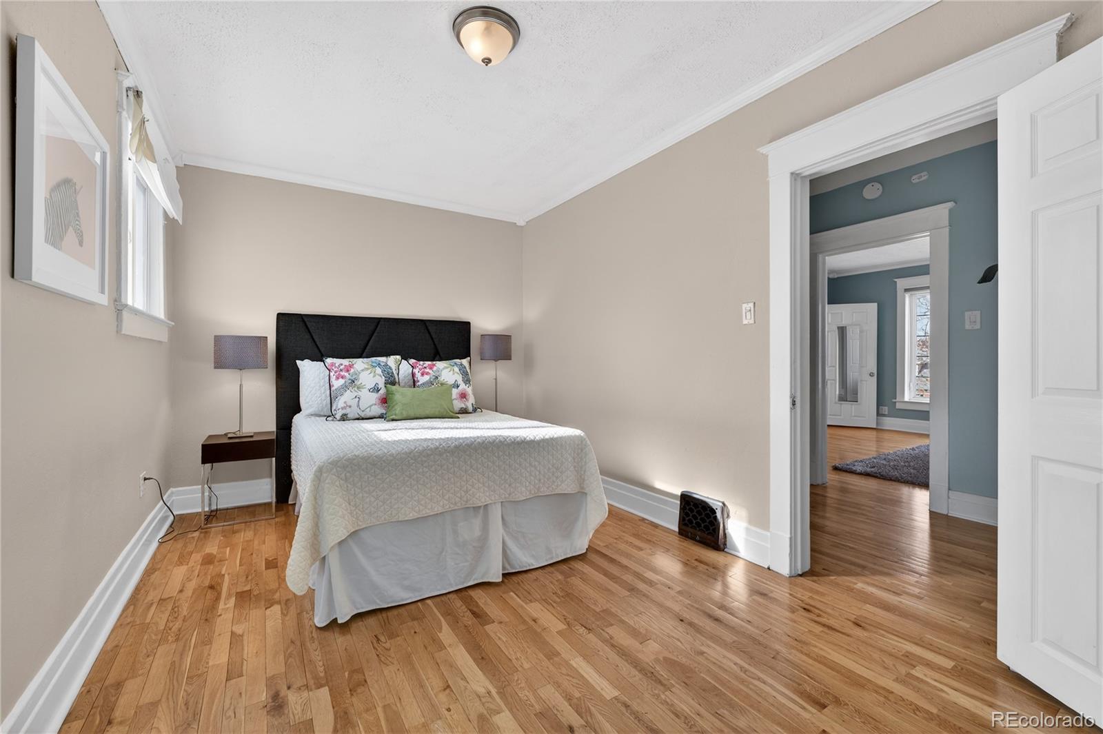 3056 York Street Denver, CO 80205 - Photo 17 of 44 a bedroom with a bed and a table