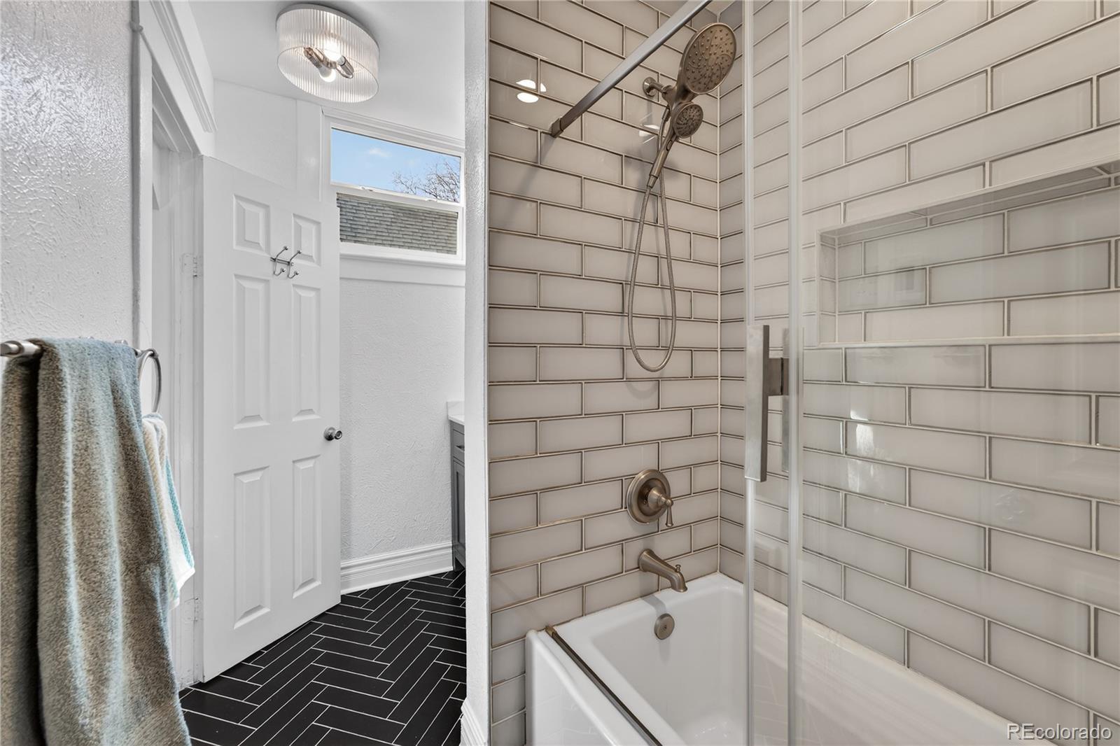 3056 York Street Denver, CO 80205 - Photo 23 of 44 a bathroom with a bathtub and a shower
