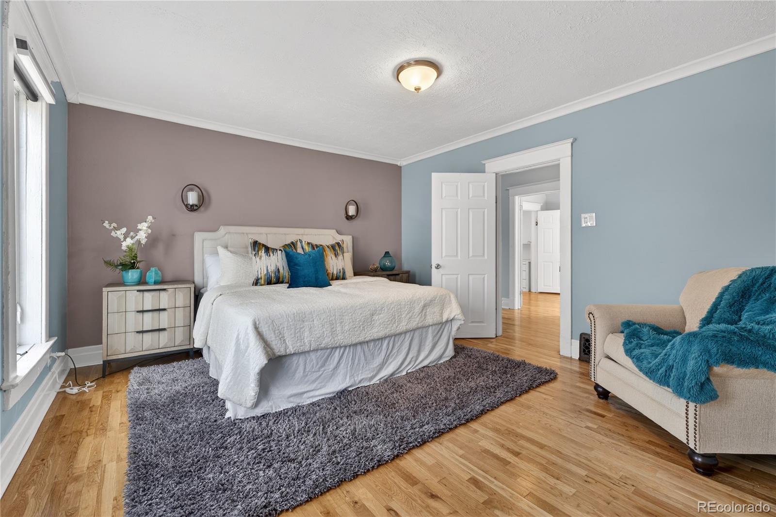 3056 York Street Denver, CO 80205 - Photo 25 of 44 a bedroom with a bed and wooden floor