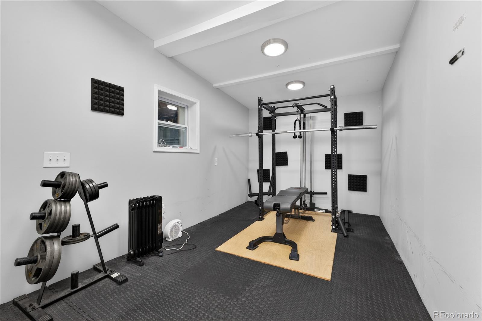 3056 York Street Denver, CO 80205 - Photo 33 of 44 a room with gym equipment and a mirror