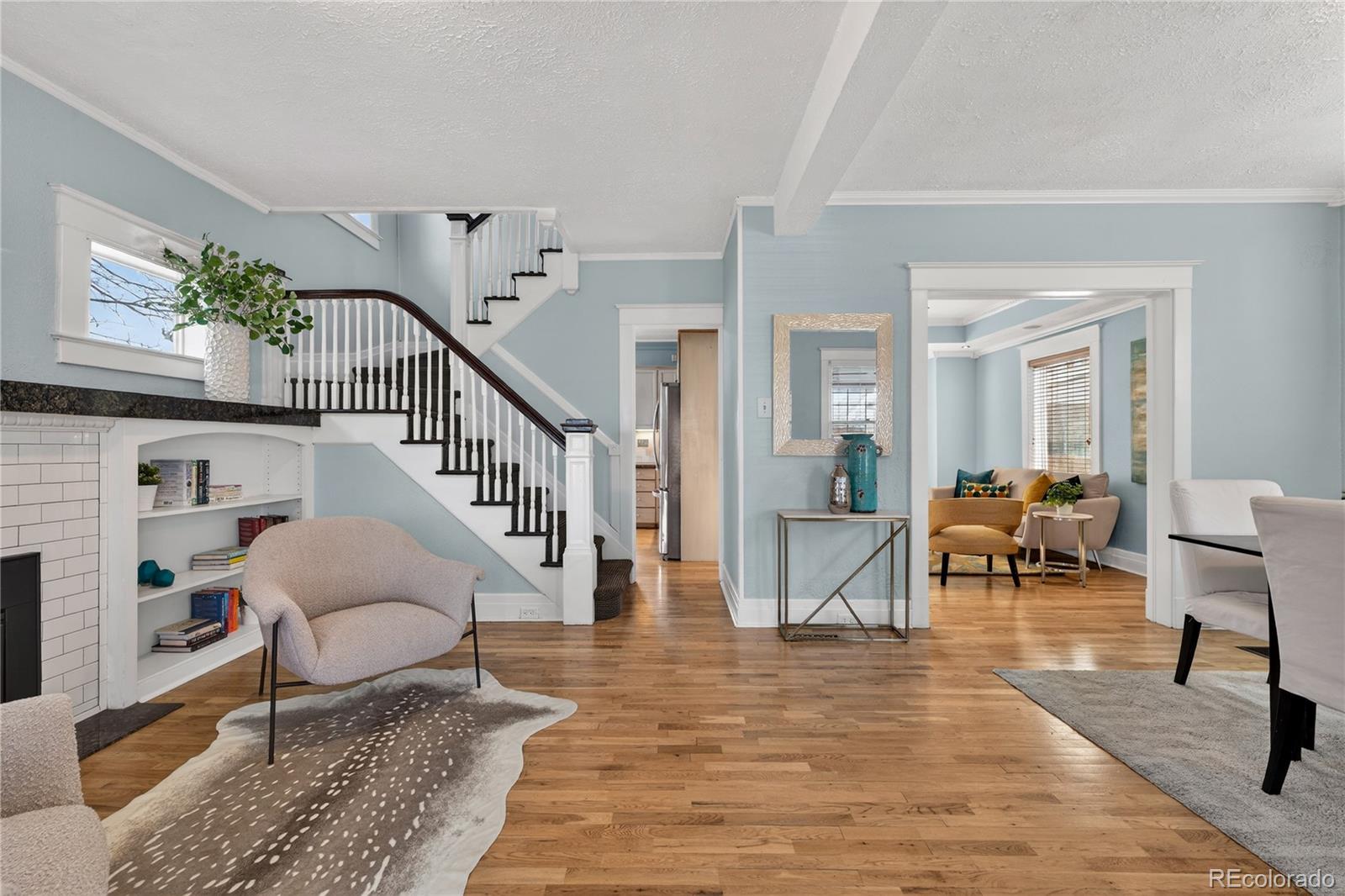 3056 York Street Denver, CO 80205 - Photo 4 of 44 a living room with furniture and a dining table with wooden floor