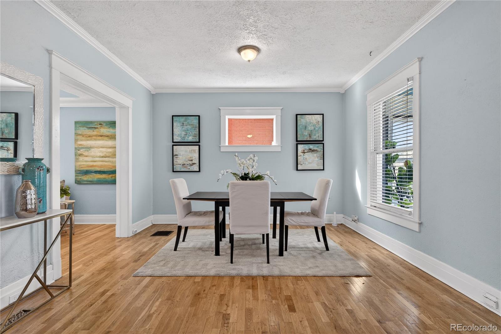 3056 York Street Denver, CO 80205 - Photo 7 of 44 a view of a dining room with furniture and wooden floor