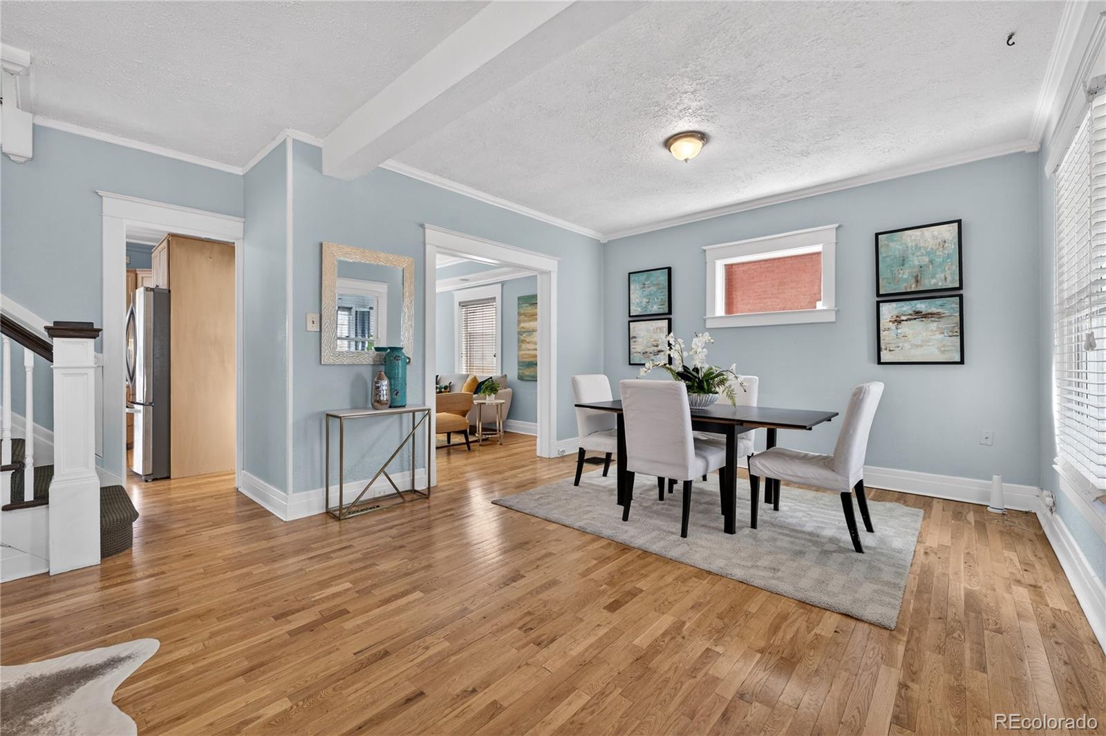 3056 York Street Denver, CO 80205 - Photo 8 of 44 a view of a dining room with furniture and wooden floor