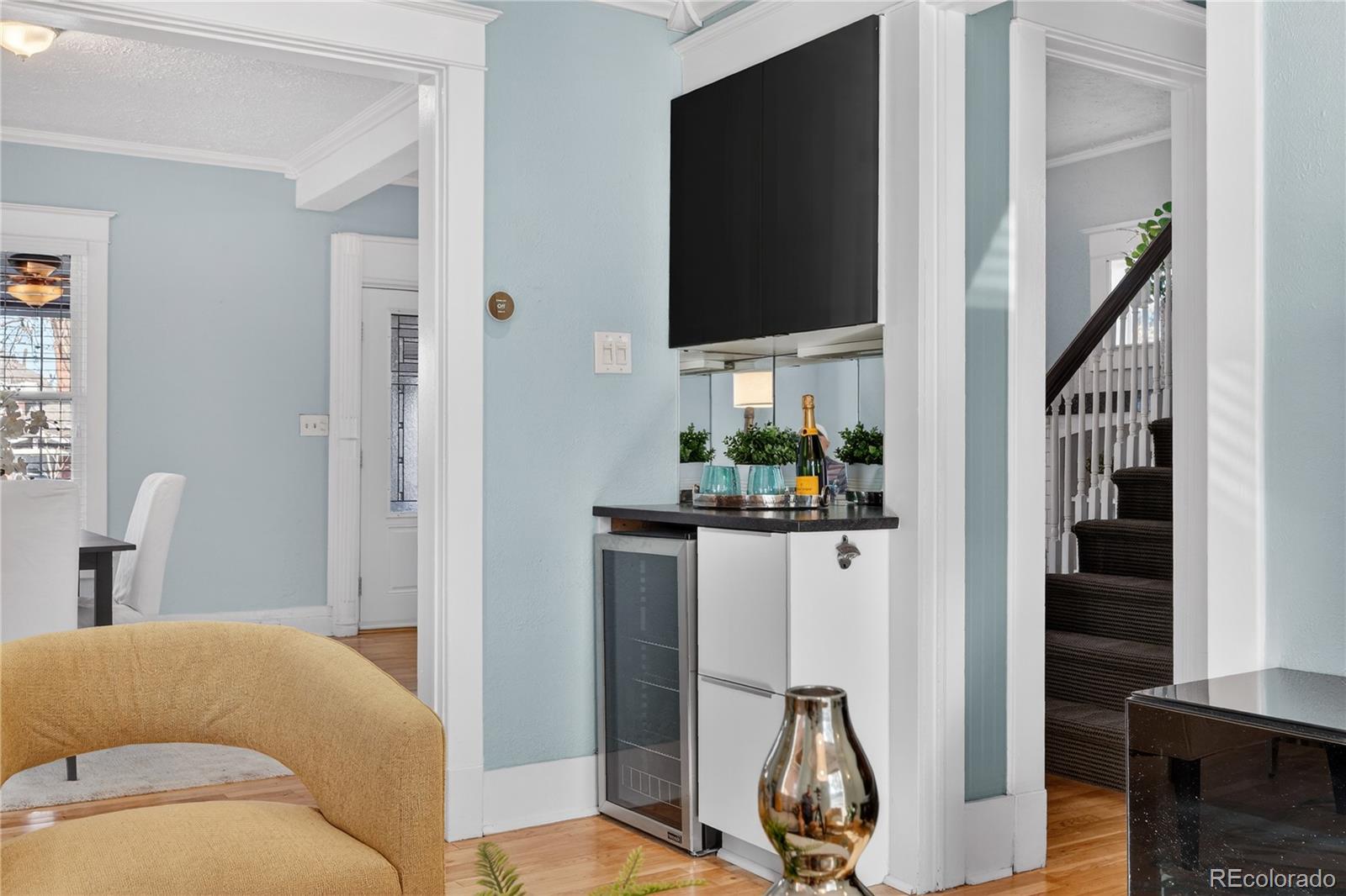 3056 York Street Denver, CO 80205 - Photo 10 of 44 a living room with furniture a flat screen tv and a window