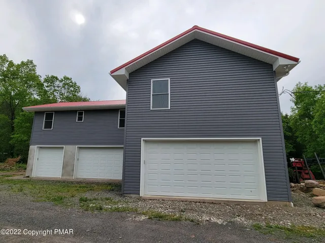 a front view of a house with garage