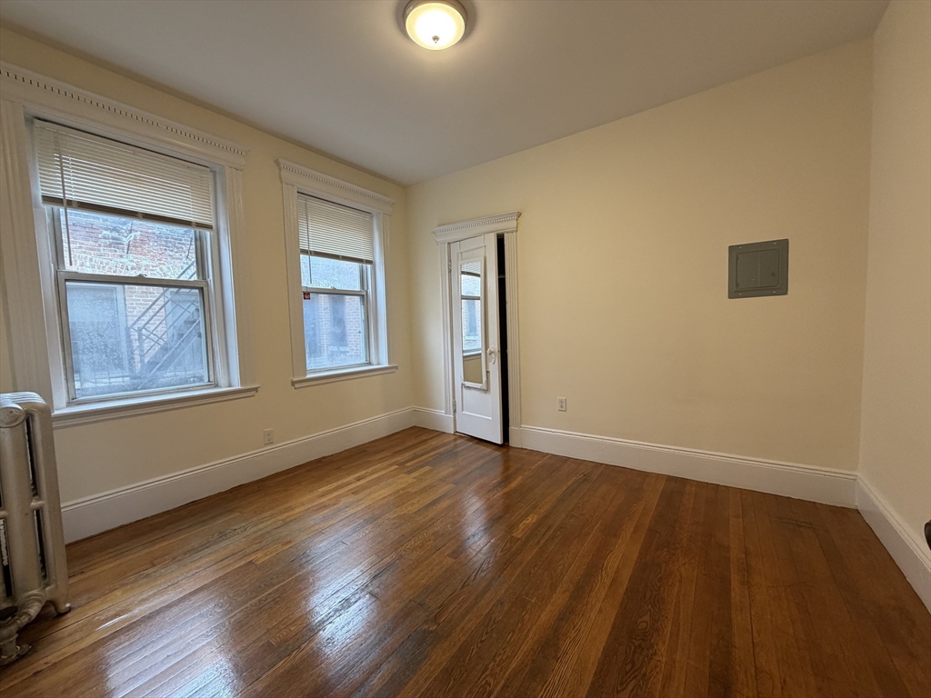 331 Huntington Avenue, Unit 45 Boston, MA 02115 - Photo 2 of 5 a view of an empty room with wooden floor and a window