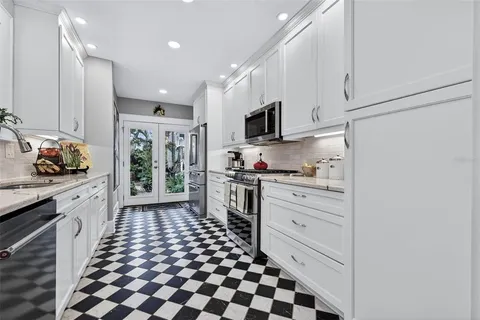 a kitchen with granite countertop a sink and a stove top oven