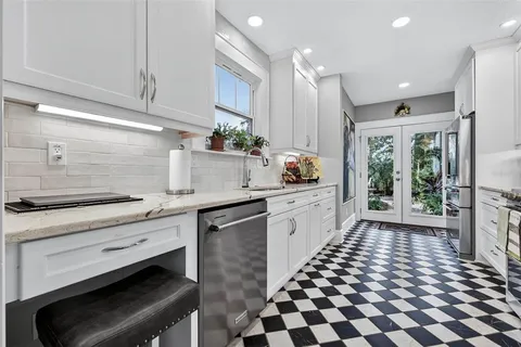 a kitchen with a sink a stove and cabinets