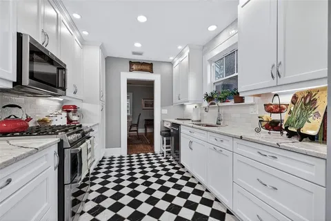 a kitchen with stainless steel appliances a stove sink microwave and cabinets