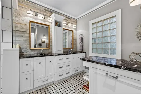 a bathroom with a granite countertop sink mirror and