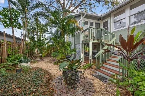 a view of a house with backyard and sitting area