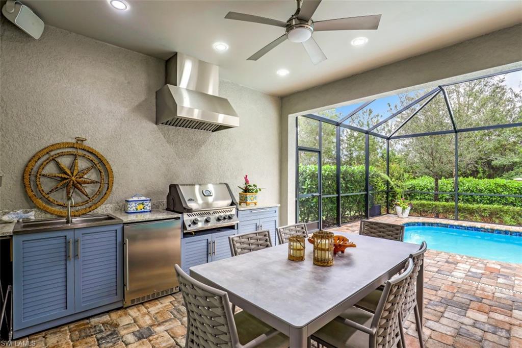 7682 Jacaranda Lane Naples, FL 34114 - Photo 13 of 30 a view of a dining room with furniture a chandelier and wooden floor
