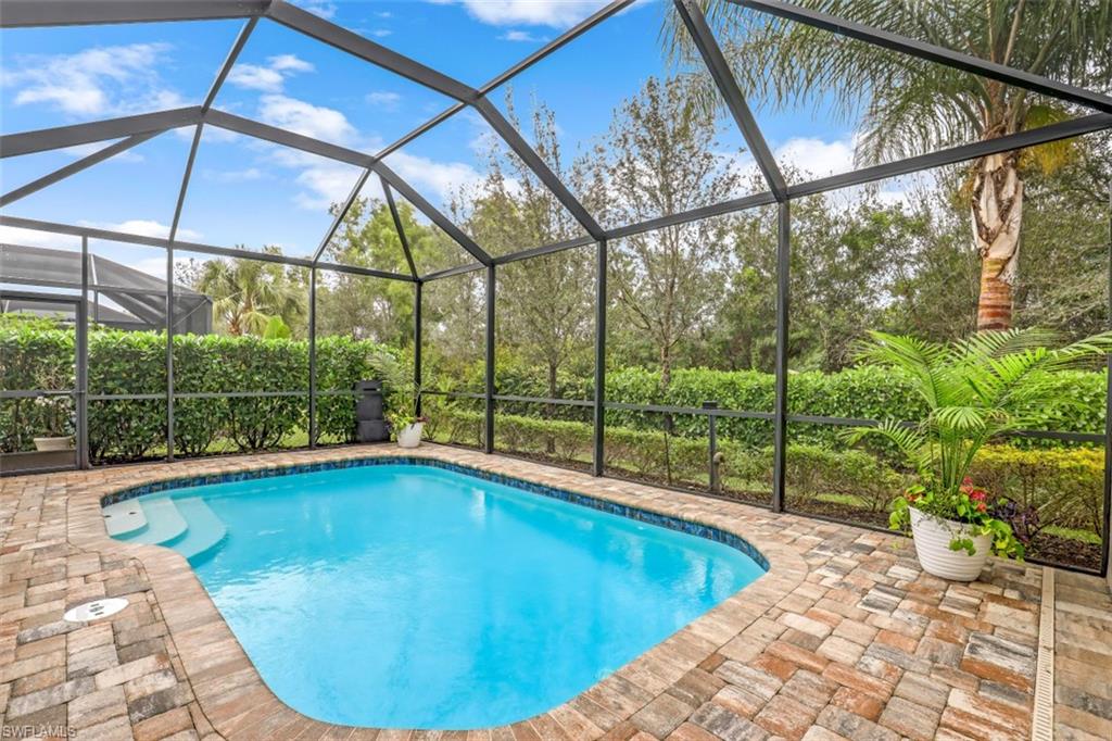 7682 Jacaranda Lane Naples, FL 34114 - Photo 14 of 30 a view of a backyard with swimming pool