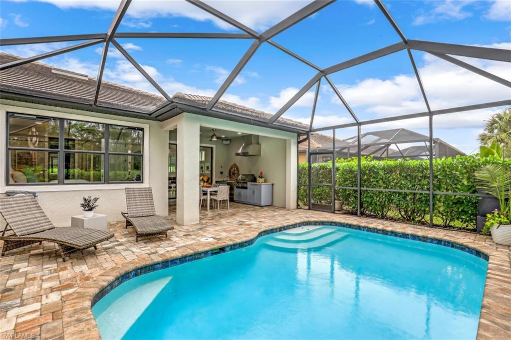 7682 Jacaranda Lane Naples, FL 34114 - Photo 15 of 30 a swimming pool with outdoor seating yard and outdoor seating