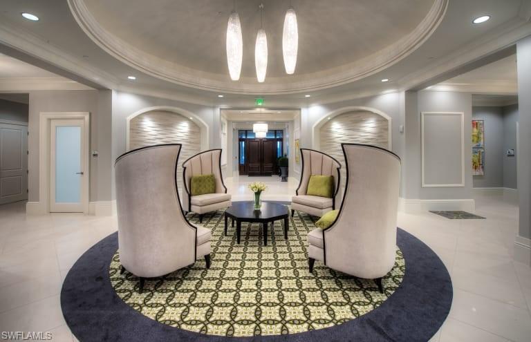 7682 Jacaranda Lane Naples, FL 34114 - Photo 18 of 30 a living room with furniture and a chandelier