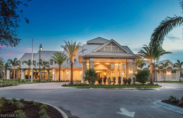 7682 Jacaranda Lane Naples, FL 34114 - Photo 19 of 30 a front view of a house with a yard and parking space