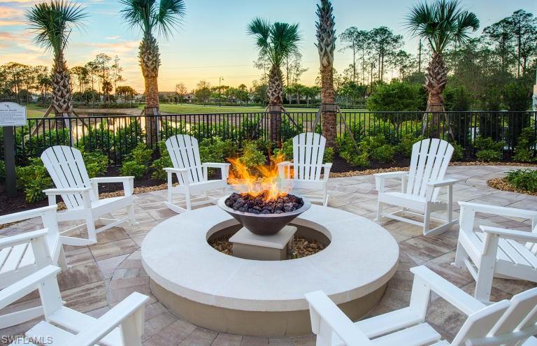 7682 Jacaranda Lane Naples, FL 34114 - Photo 20 of 30 a view of a lake with a table and chairs