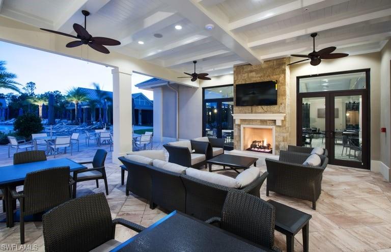 7682 Jacaranda Lane Naples, FL 34114 - Photo 22 of 30 a living room with fireplace furniture and a flat screen tv