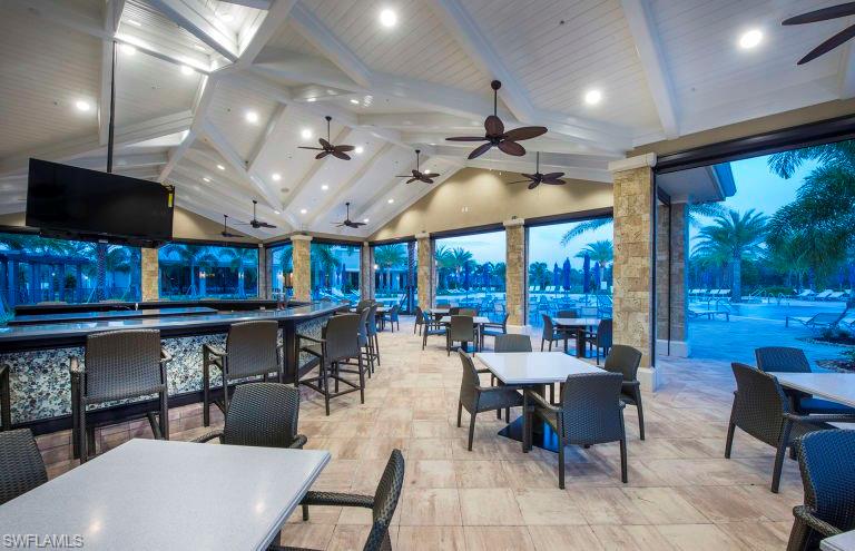7682 Jacaranda Lane Naples, FL 34114 - Photo 24 of 30 a living room with lots of furniture and a flat screen tv