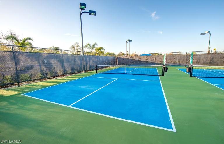7682 Jacaranda Lane Naples, FL 34114 - Photo 27 of 30 a view of an outdoor space and tennis court