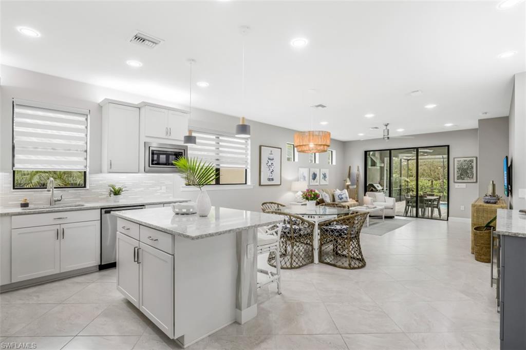 7682 Jacaranda Lane Naples, FL 34114 - Photo 4 of 30 a kitchen with lots of counter top space and living room