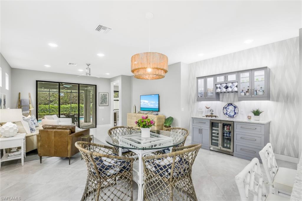 7682 Jacaranda Lane Naples, FL 34114 - Photo 5 of 30 a view of a dining room with furniture and chandelier