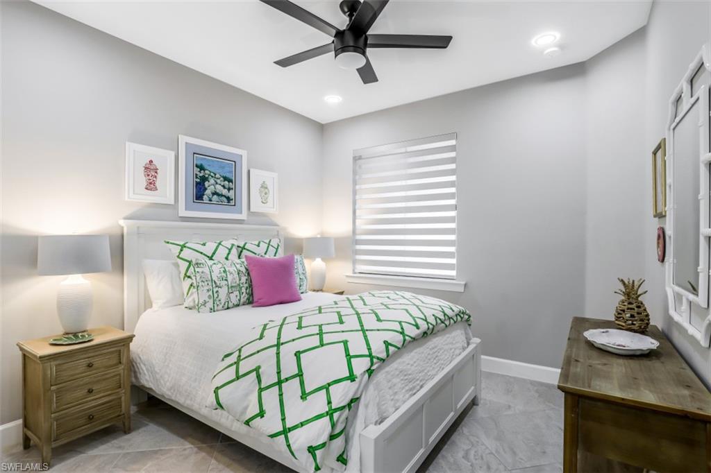 7682 Jacaranda Lane Naples, FL 34114 - Photo 10 of 30 a bedroom with a bed and a dresser in it