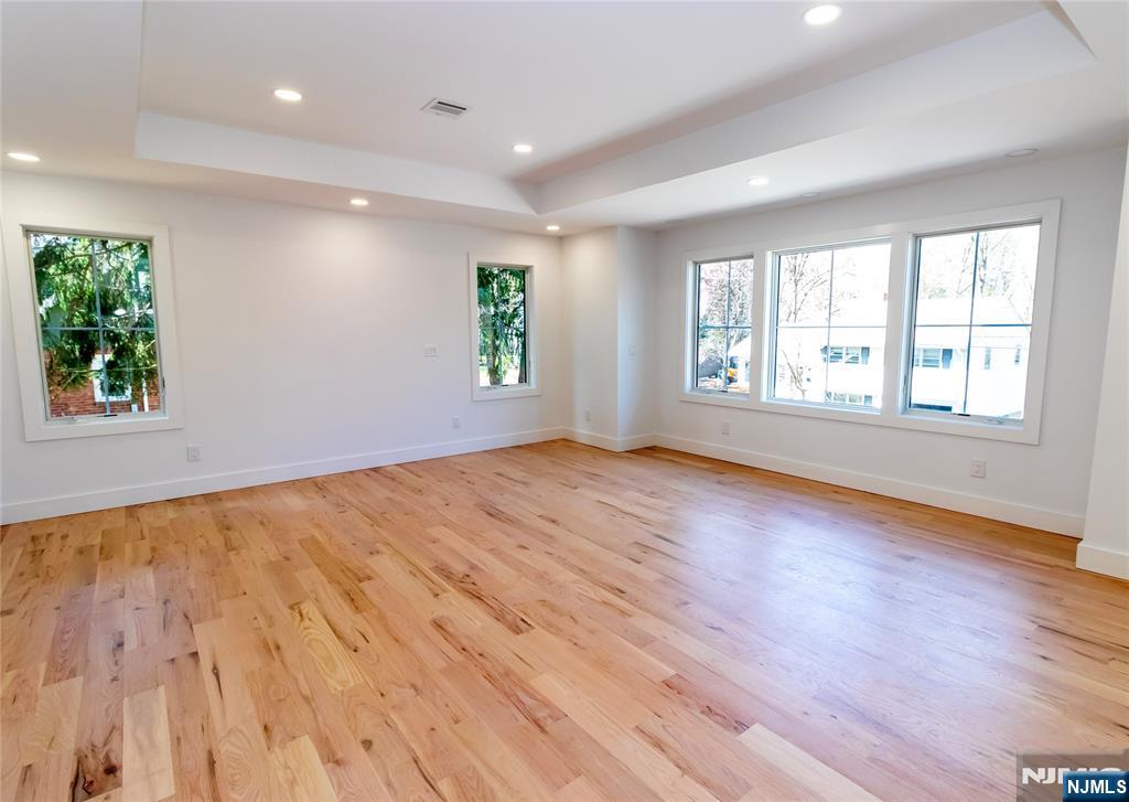 42 Harvey Street Closter, NJ 07624 - Photo 17 of 33 an empty room with wooden floor and windows