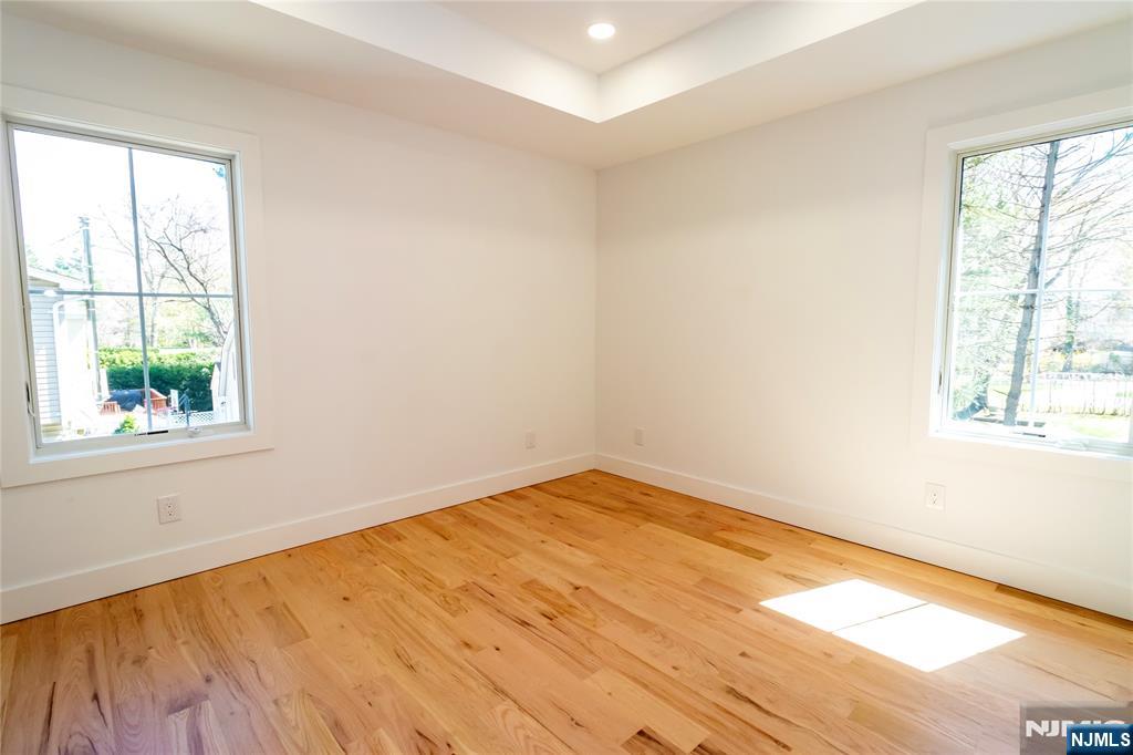 42 Harvey Street Closter, NJ 07624 - Photo 23 of 33 a view of empty room with wooden floor and fan