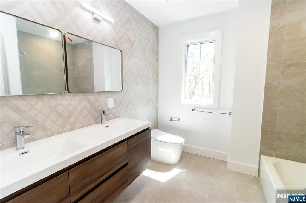 42 Harvey Street Closter, NJ 07624 - Photo 24 of 33 a bathroom with a sink and a mirror