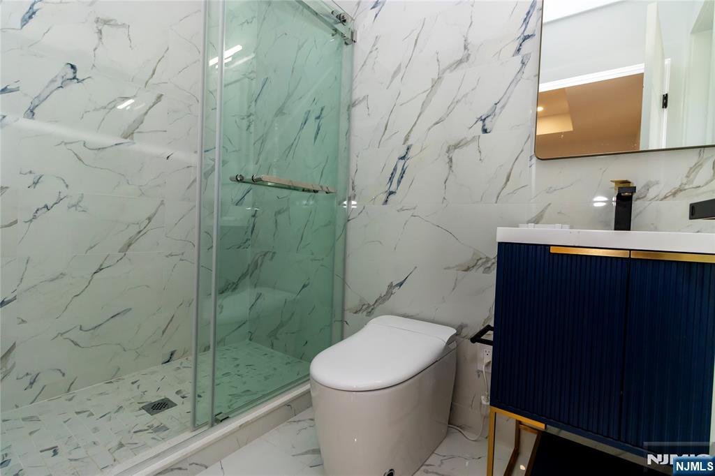 42 Harvey Street Closter, NJ 07624 - Photo 26 of 33 a bathroom with a sink a toilet and shower