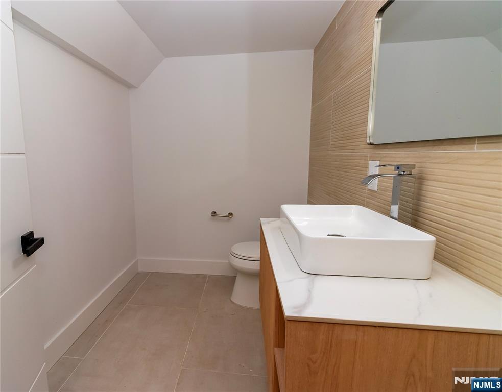 42 Harvey Street Closter, NJ 07624 - Photo 27 of 33 a bathroom with a sink a toilet and shower