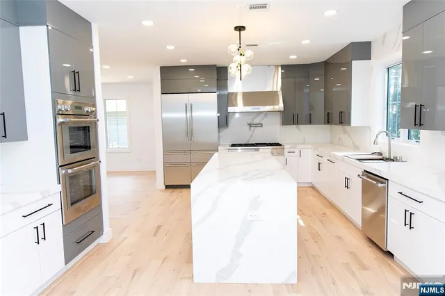 a large kitchen with a large counter top appliances and cabinets