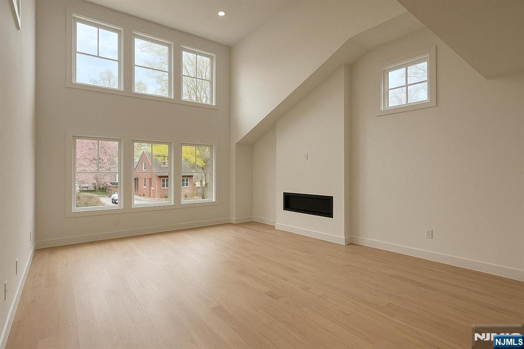 42 Harvey Street Closter, NJ 07624 - Photo 8 of 33 a view of an empty room with wooden floor and a window