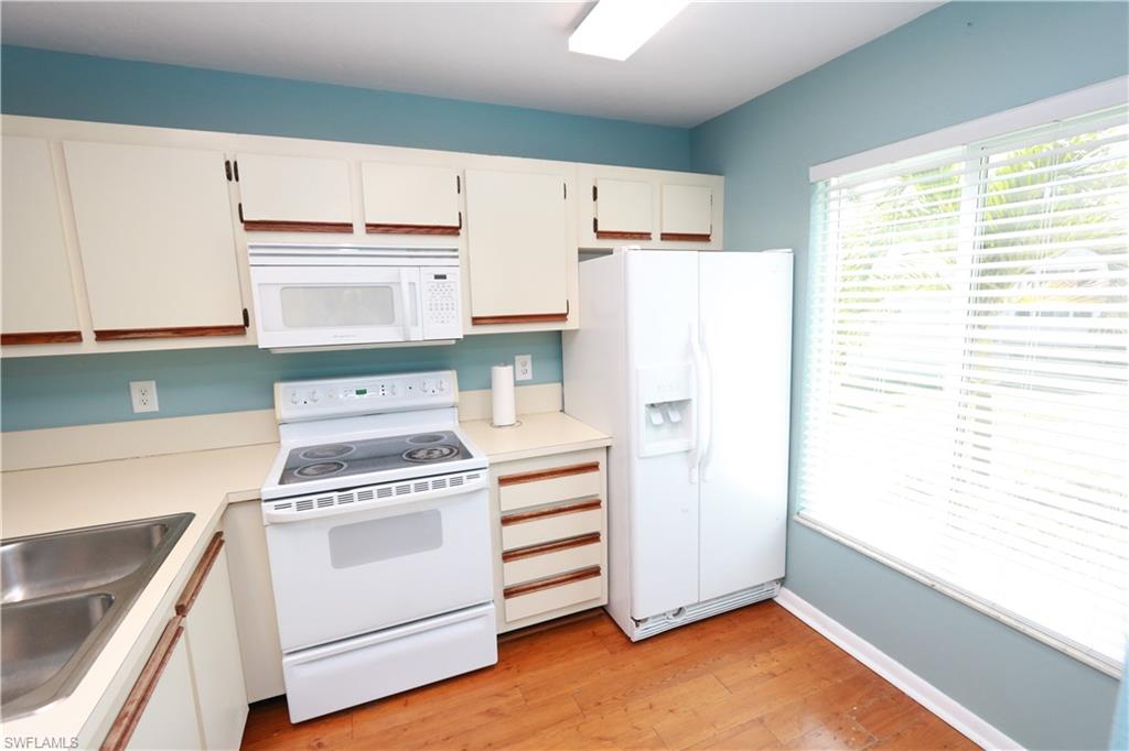 2207 San Marco Road, Unit 4104 Marco Island, FL 34145 - Photo 4 of 10 a kitchen with a stove a refrigerator and a sink