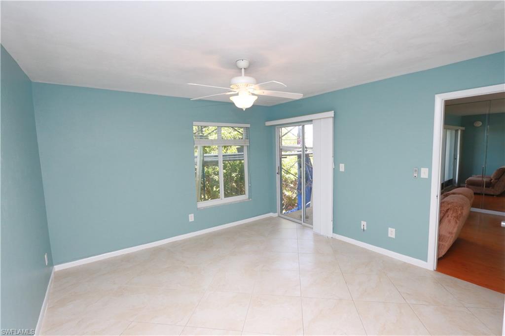 2207 San Marco Road, Unit 4104 Marco Island, FL 34145 - Photo 7 of 10 a view of an empty room with window and chandelier fan