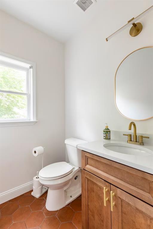 673 Windsor Street Southwest Atlanta, GA 30310 - Photo 13 of 29 a bathroom with a granite countertop toilet sink mirror and vanity