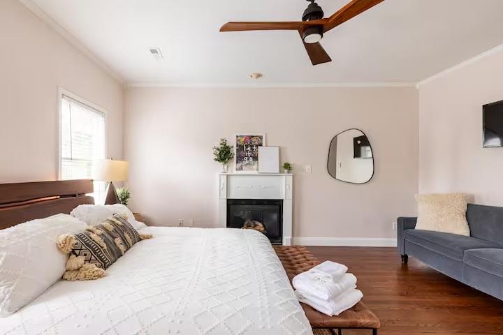 673 Windsor Street Southwest Atlanta, GA 30310 - Photo 15 of 29 a bedroom with a bed couch and a window