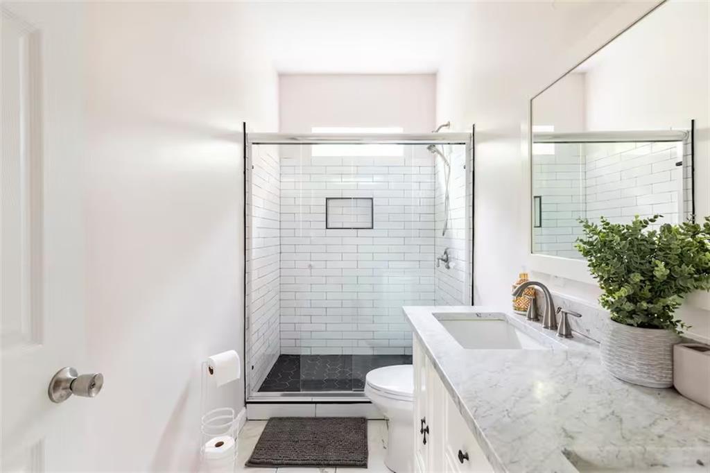 673 Windsor Street Southwest Atlanta, GA 30310 - Photo 16 of 29 a bathroom with a sink toilet and shower