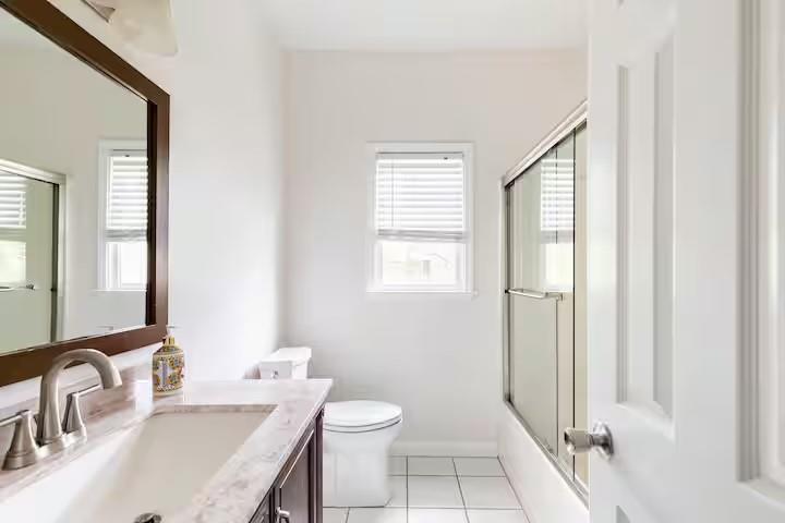 673 Windsor Street Southwest Atlanta, GA 30310 - Photo 17 of 29 a bathroom with a sink toilet and shower