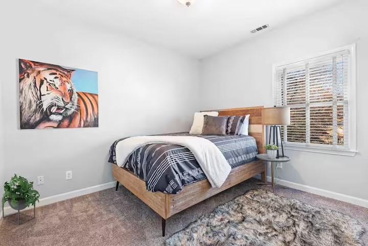 673 Windsor Street Southwest Atlanta, GA 30310 - Photo 18 of 29 a bedroom with a bed and a window