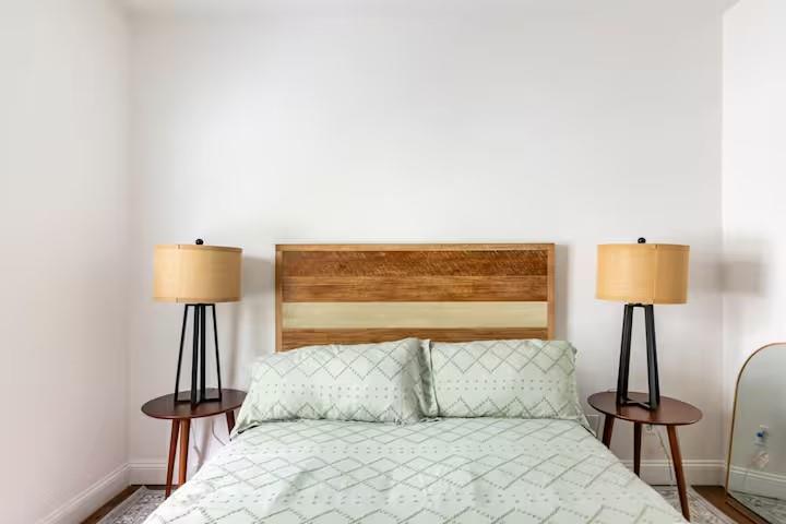 673 Windsor Street Southwest Atlanta, GA 30310 - Photo 19 of 29 a bedroom with a bed and a lamp on table