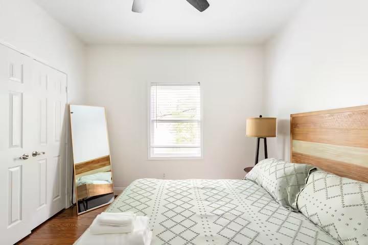 673 Windsor Street Southwest Atlanta, GA 30310 - Photo 20 of 29 a bedroom with a bed and a window