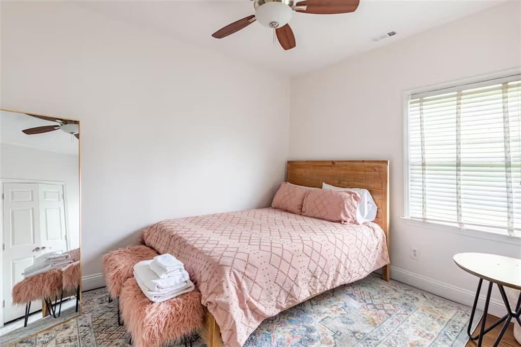 673 Windsor Street Southwest Atlanta, GA 30310 - Photo 22 of 29 a bedroom with a bed and a window