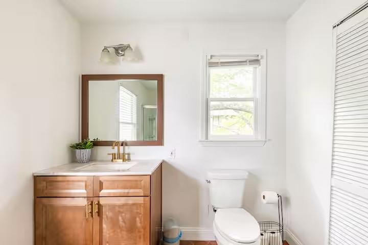 673 Windsor Street Southwest Atlanta, GA 30310 - Photo 29 of 29 a bathroom with a toilet sink and mirror