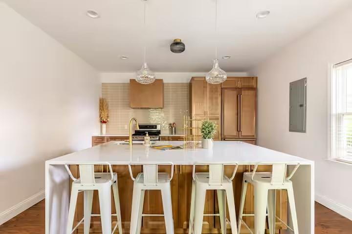 673 Windsor Street Southwest Atlanta, GA 30310 - Photo 3 of 29 a kitchen with a table chairs and a refrigerator